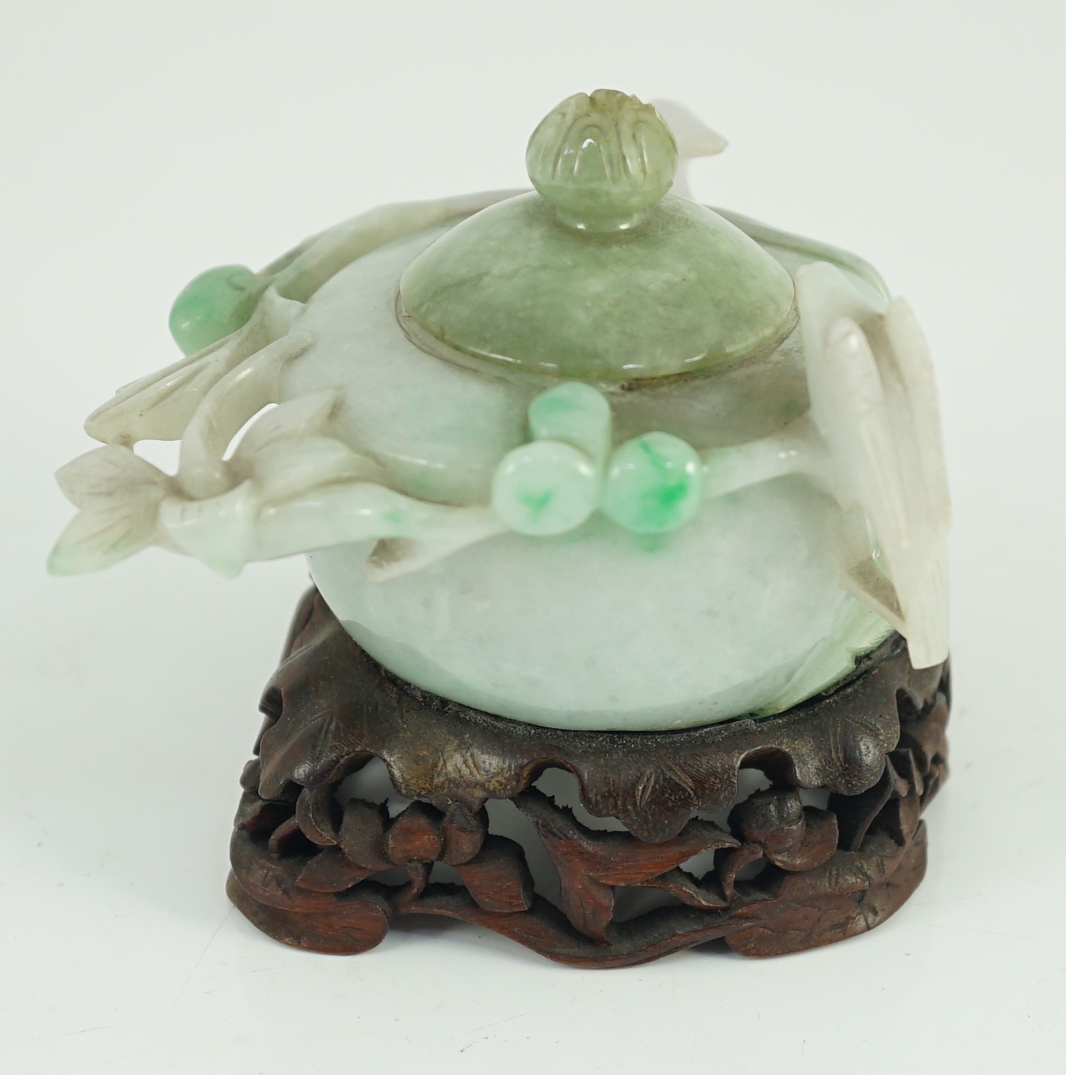 A Chinese lavender and green jadeite water pot and stand, late 19th century, 9.3cm at widest point, wood stand